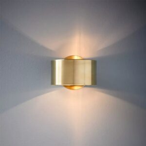 Lenuistt Up Down Drum Golden Wall Lamp - A modern, gold-colored wall sconce mounted on a gray wall. The sconce has a cylindrical shape with a cut-out section, allowing light to emit both upwards and downwards.