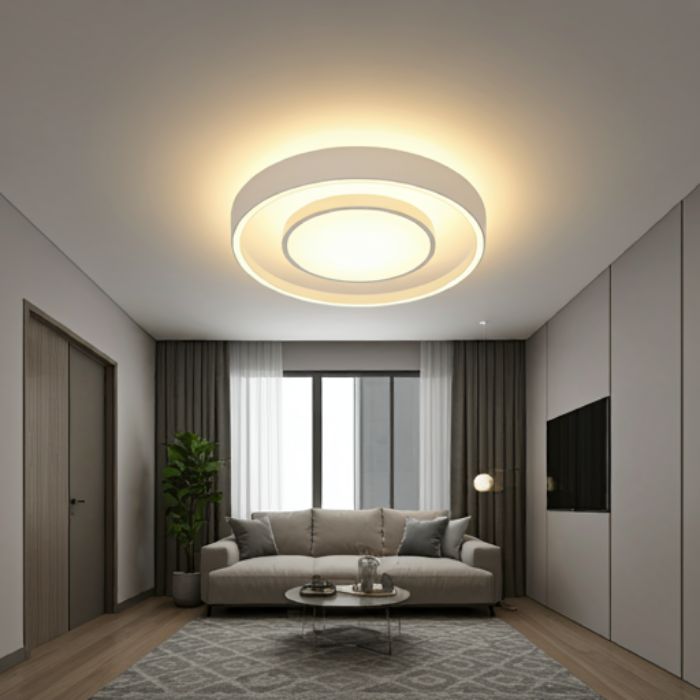 A modern living room with a sleek, circular flush mount ceiling light. The light illuminates the space with a warm, ambient glow, creating a cozy and inviting atmosphere.