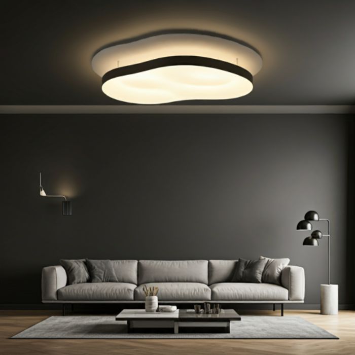 A modern living room with a sleek, organic-shaped flush mount ceiling light. The light illuminates the space with a warm, ambient glow, creating a stylish and contemporary atmosphere.